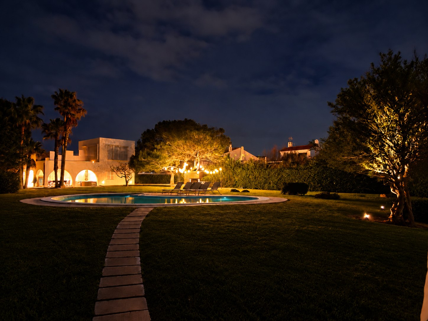 The villa and pool — night panorama